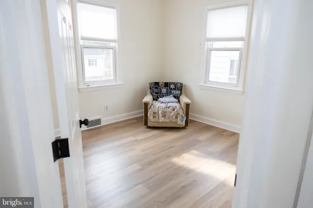 a view of a room with wooden floor and window