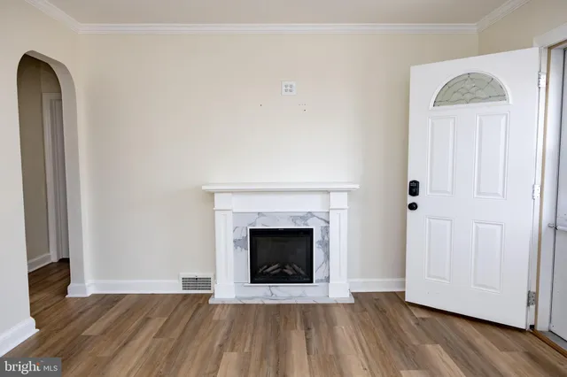a view of a livingroom with wooden floor and a ceiling fan