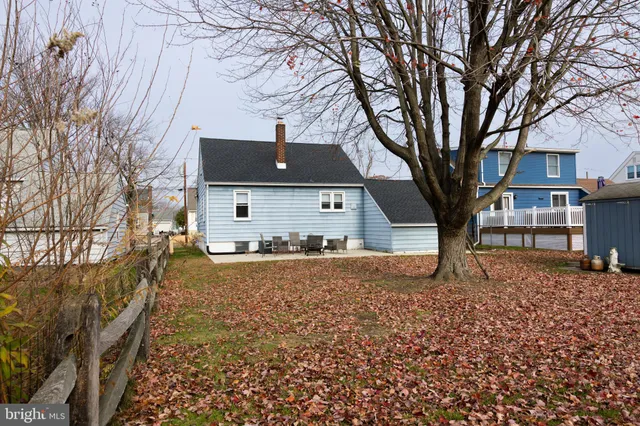 a view of a house with a yard covered in snow and a tub