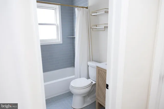 a bathroom with a toilet and a bathtub
