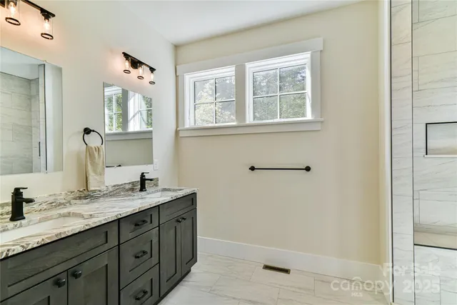 a bathroom with a granite countertop sink mirror and double