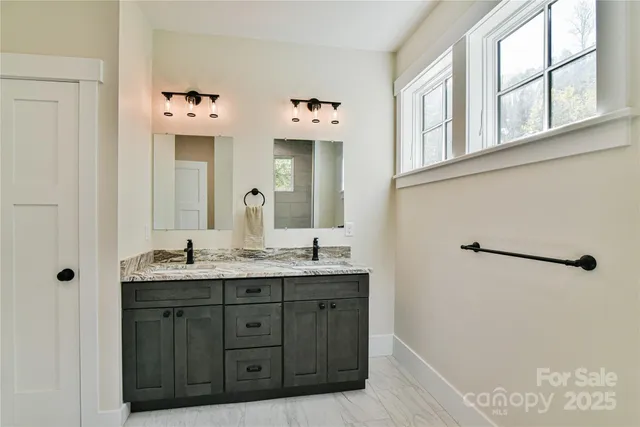 a bathroom with a double vanity sink and mirror