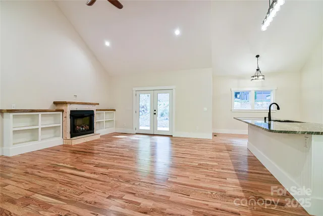 a view of a kitchen with a sink and a fireplace