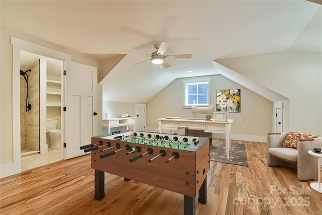 a living room with furniture a wooden floor and a sink