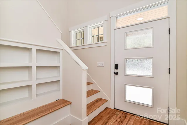 a view of an entryway with wooden floor