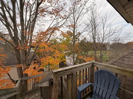 a view of a balcony with wooden fence and floor