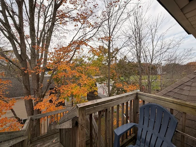 a view of a balcony with wooden fence and floor