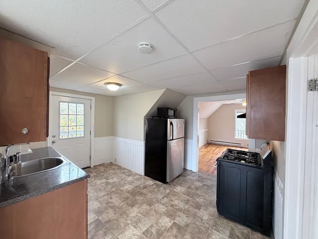 a kitchen with a refrigerator and a sink