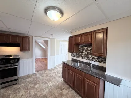 a kitchen with stainless steel appliances granite countertop a stove and a refrigerator