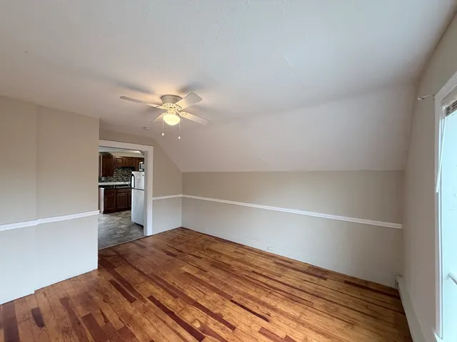 a view of an empty room and wooden floor