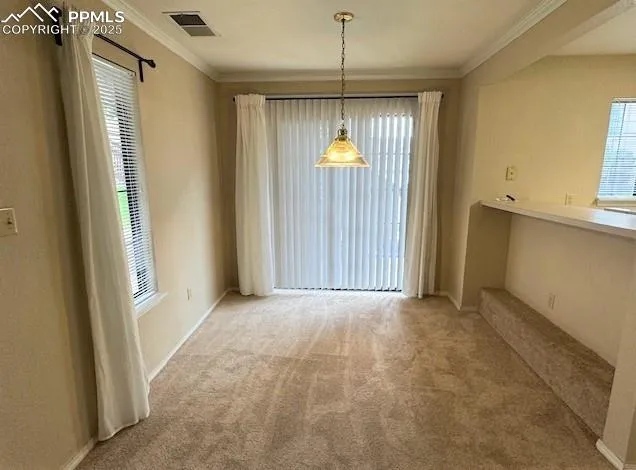 an empty room with windows and chandelier fan