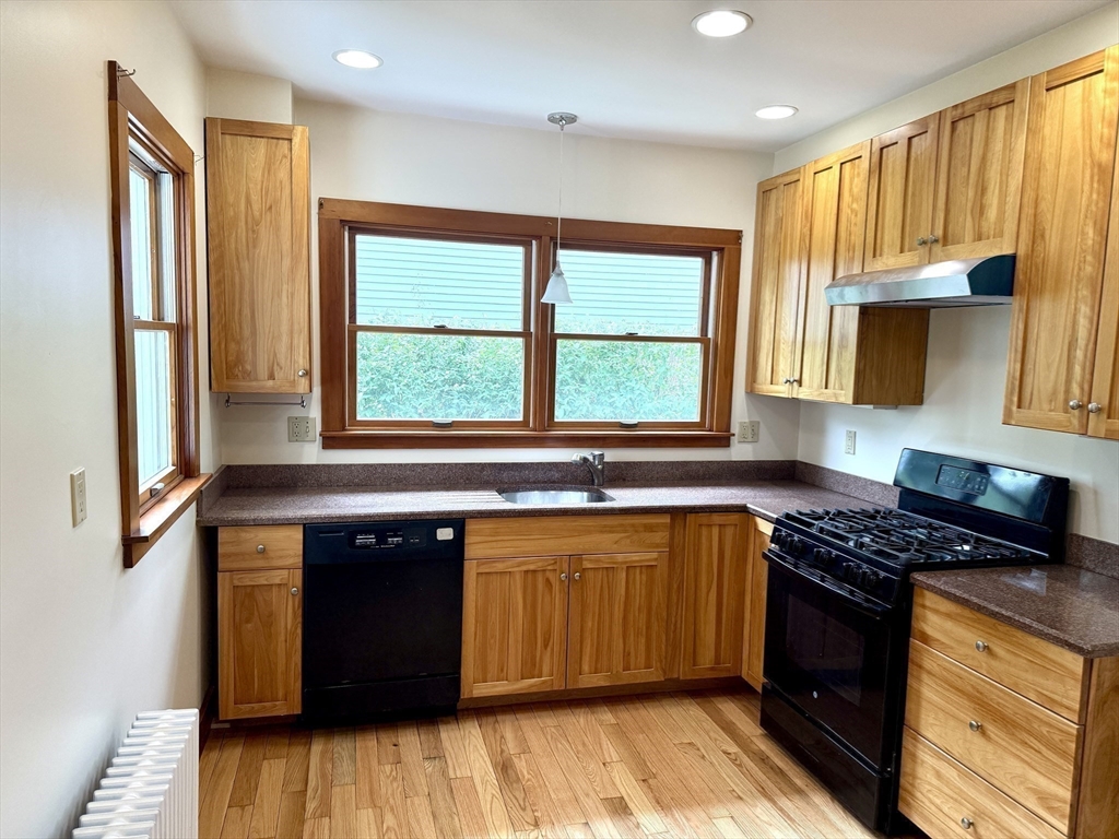 39 Newman Road Malden, MA 02148 - Photo 9 of 27 a kitchen with stainless steel appliances granite countertop a stove a sink dishwasher and a microwave oven with cabinets