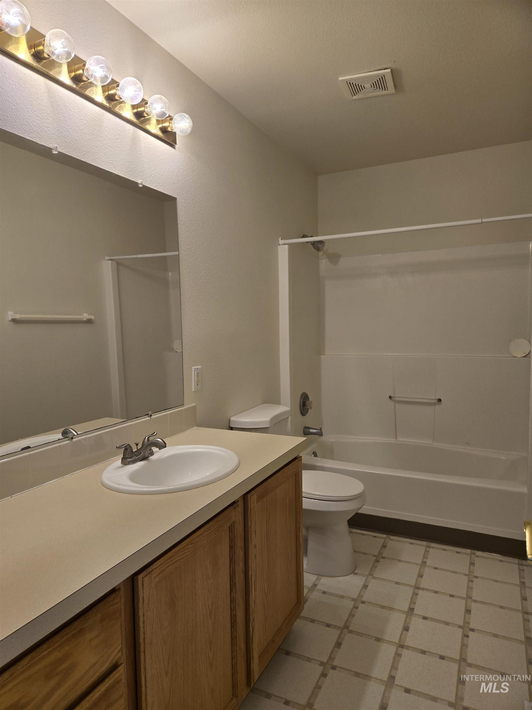 183 Southwest 18th Street Ontario, OR 97914 - Photo 18 of 32 Bathroom featuring vanity, shower / tub combination, and light flooring