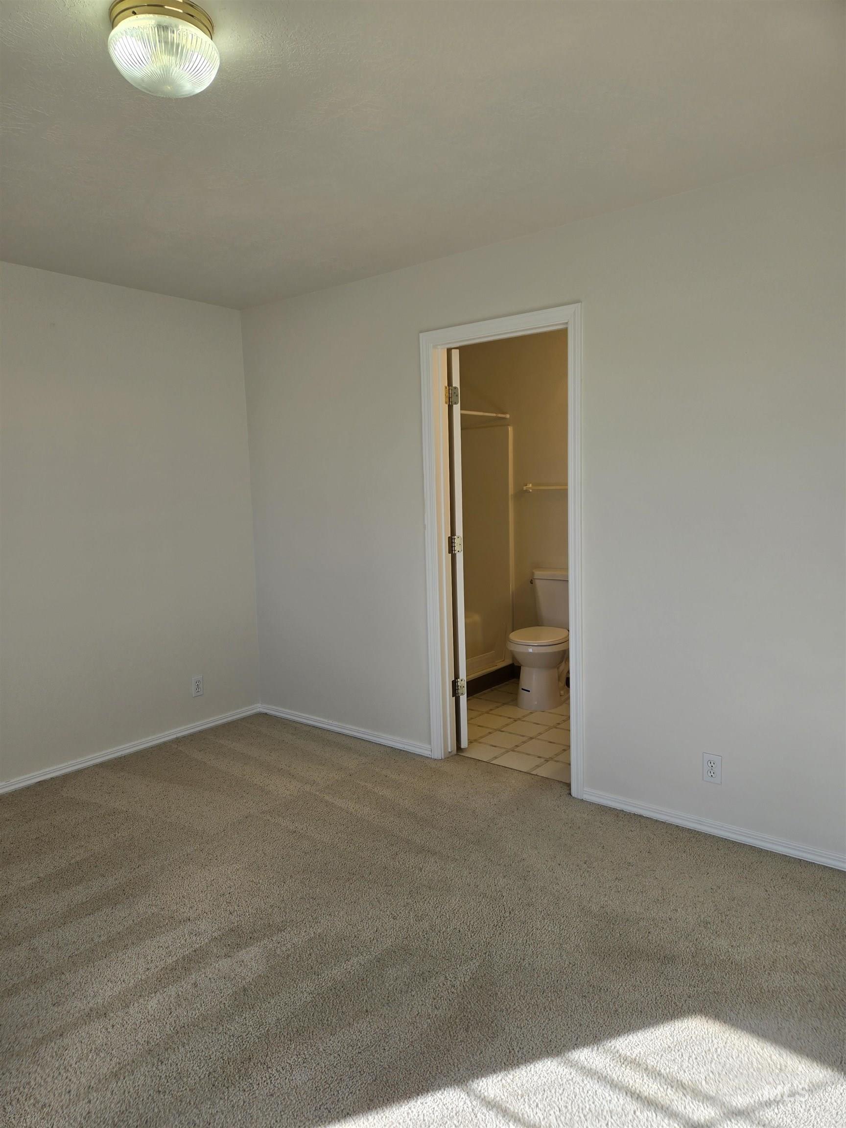 183 Southwest 18th Street Ontario, OR 97914 - Photo 23 of 32 Unfurnished bedroom featuring light carpet and connected bathroom