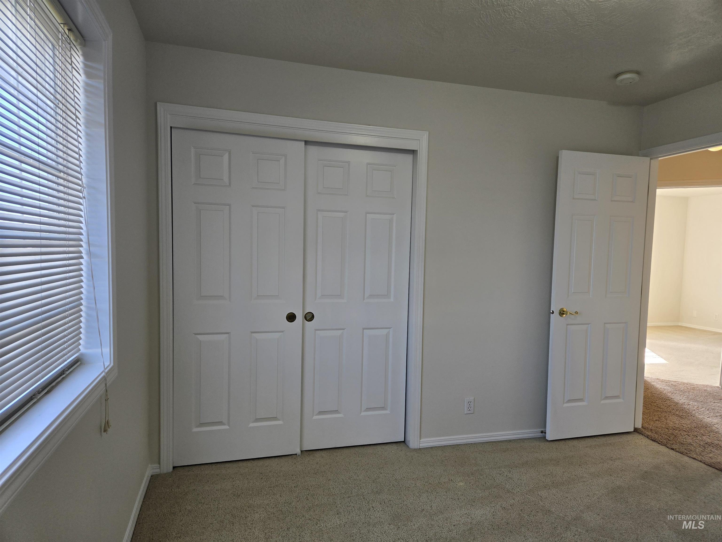 183 Southwest 18th Street Ontario, OR 97914 - Photo 30 of 32 Unfurnished bedroom with light carpet and a closet