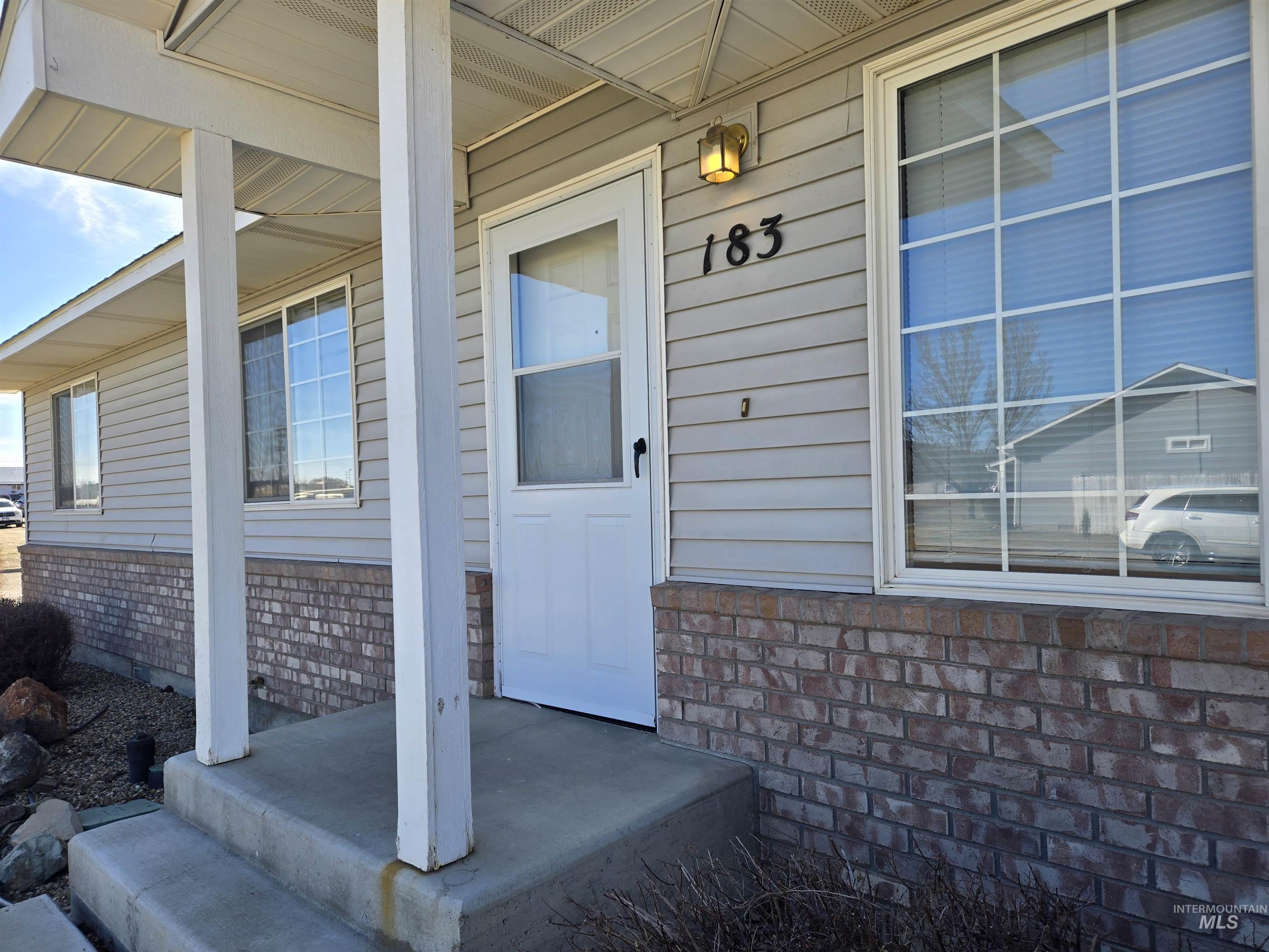 183 Southwest 18th Street Ontario, OR 97914 - Photo 3 of 32 Doorway to property with covered porch and brick siding
