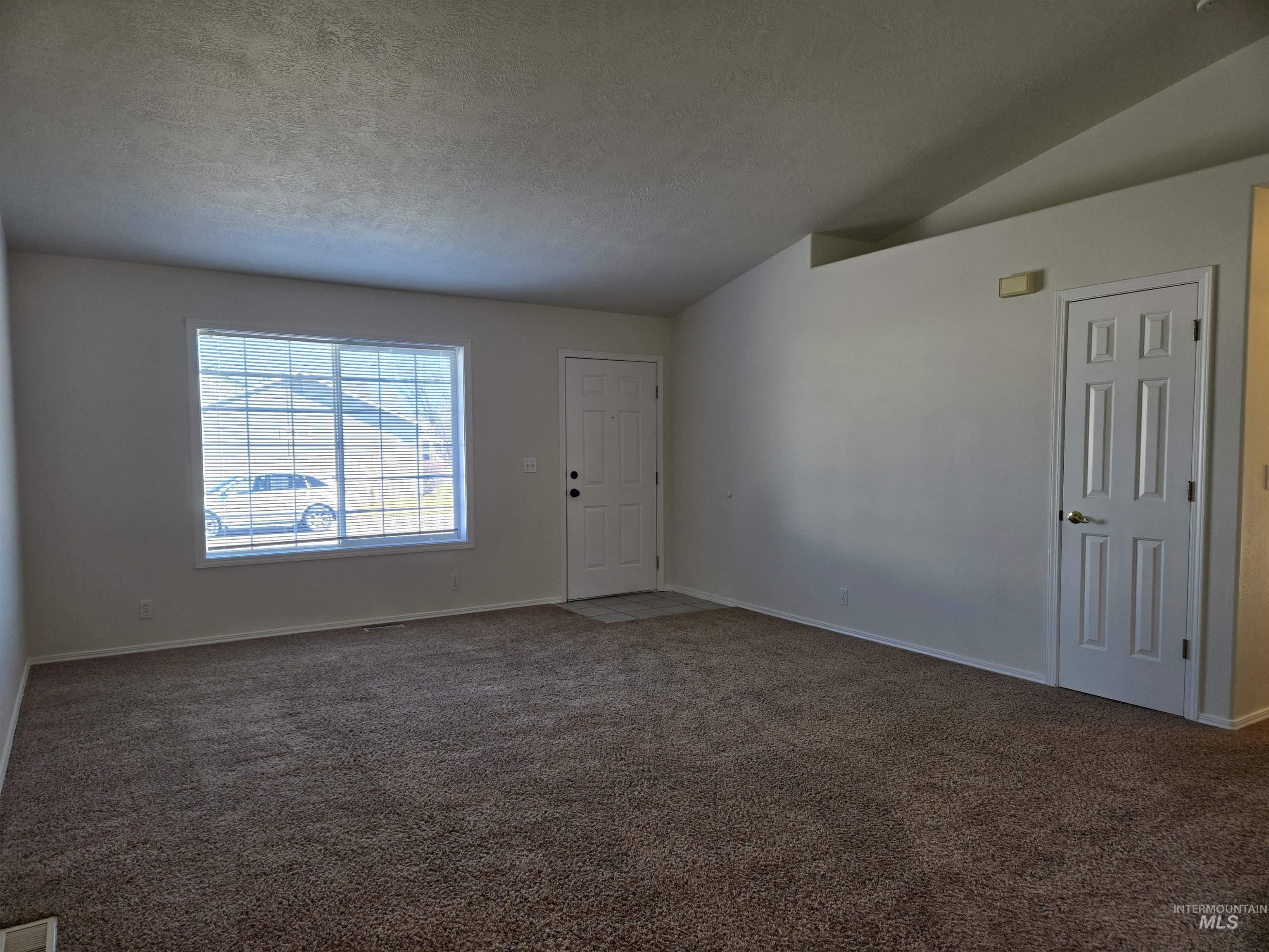 183 Southwest 18th Street Ontario, OR 97914 - Photo 7 of 32 Empty room featuring dark carpet and baseboards