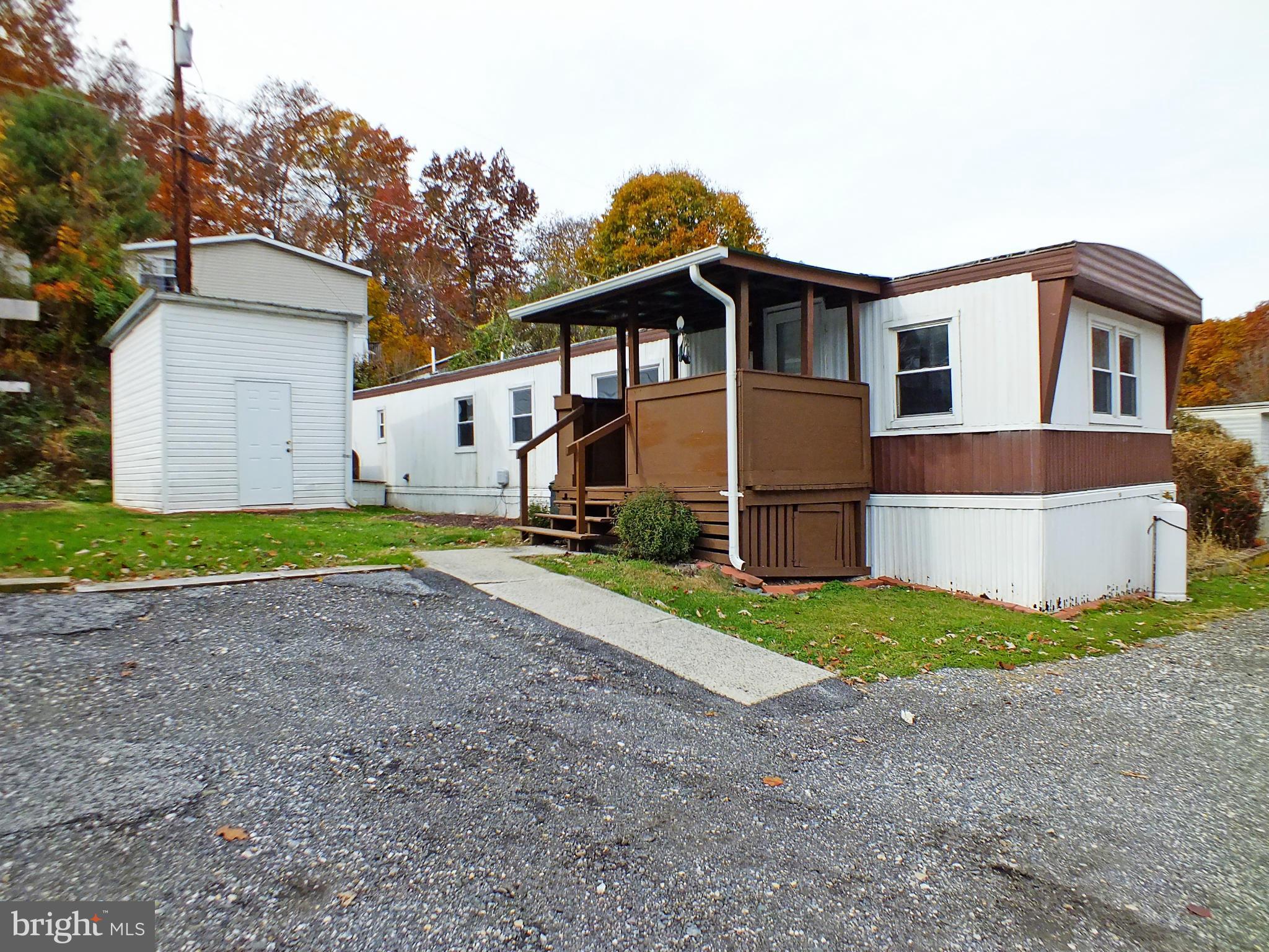 2439 Fairmount Road, Unit 16 Hampstead, MD 21074 - Photo 1 of 17 a front view of a house with a yard and garage