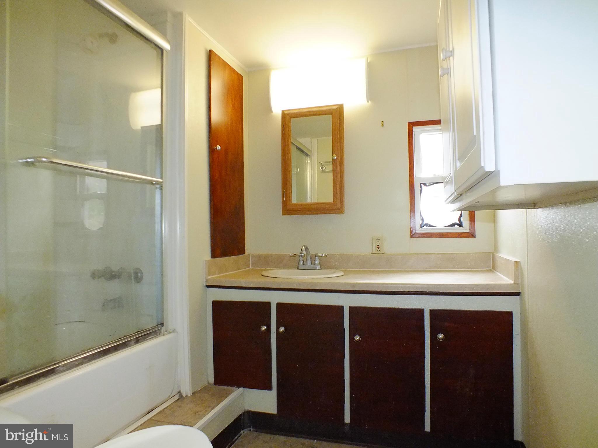 2439 Fairmount Road, Unit 16 Hampstead, MD 21074 - Photo 15 of 17 a bathroom with a granite countertop sink mirror and double
