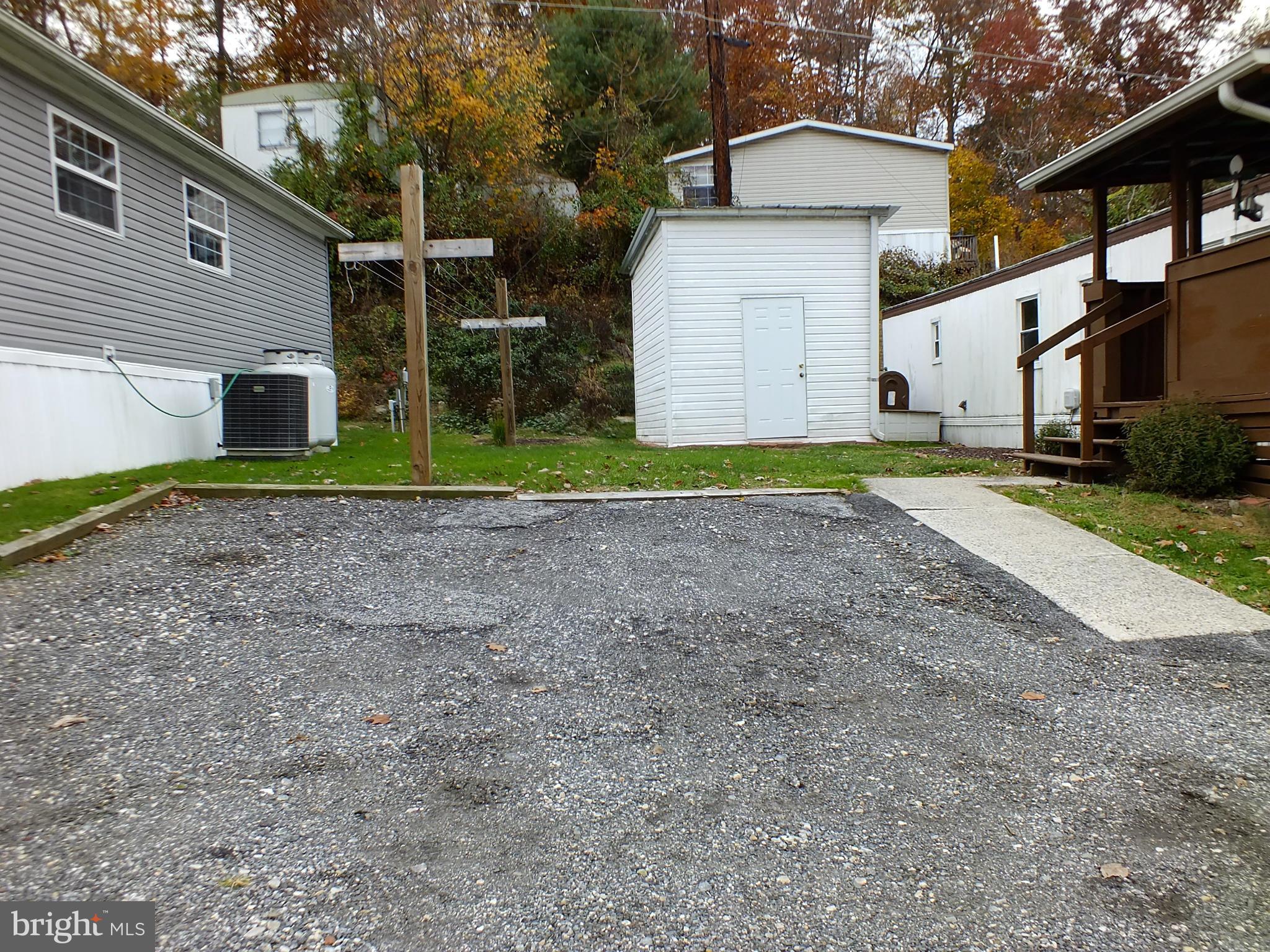 2439 Fairmount Road, Unit 16 Hampstead, MD 21074 - Photo 4 of 17 a view of backyard of house and car parked