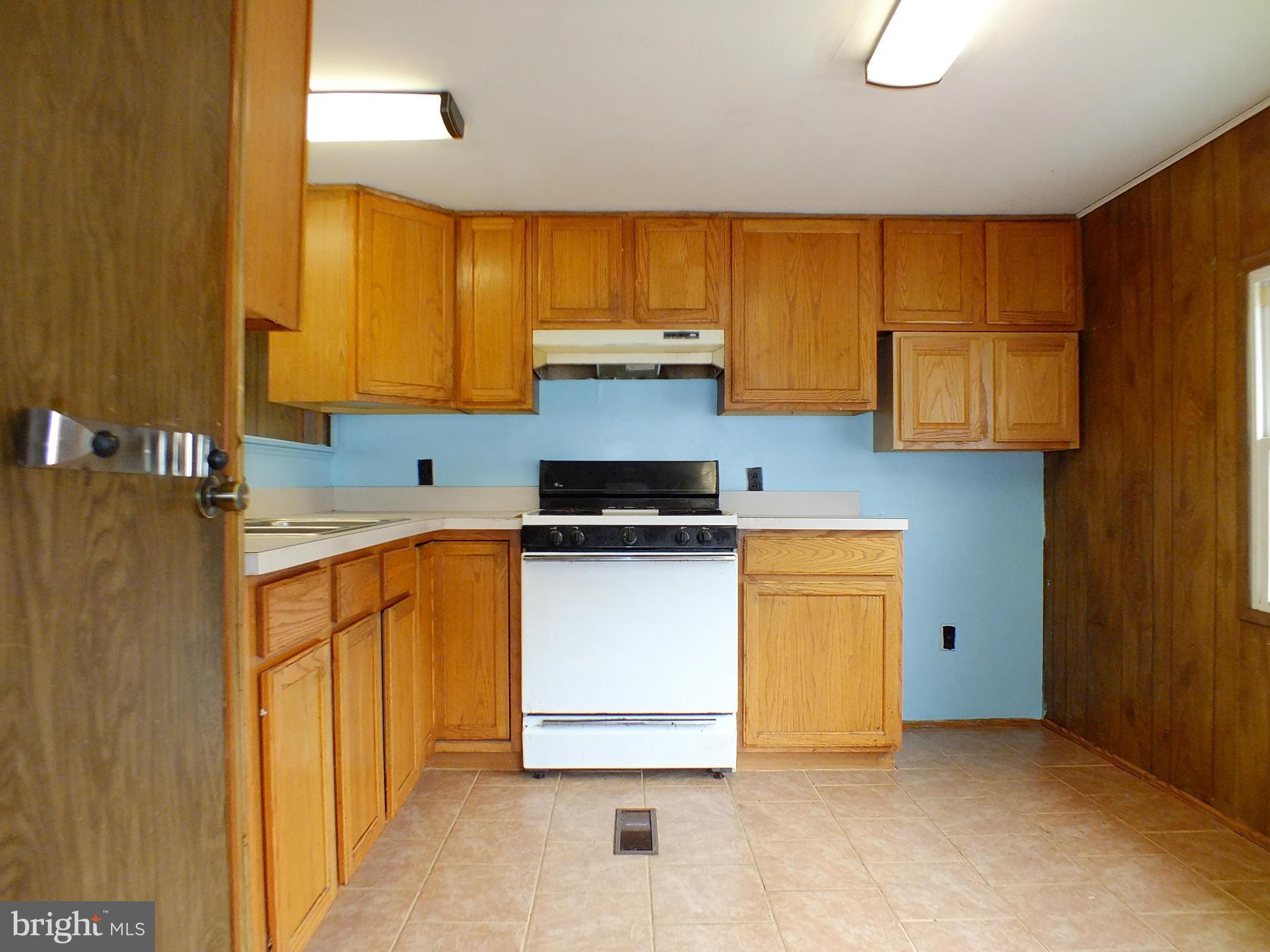 2439 Fairmount Road, Unit 16 Hampstead, MD 21074 - Photo 8 of 17 a kitchen with stainless steel appliances granite countertop a stove a sink and a refrigerator