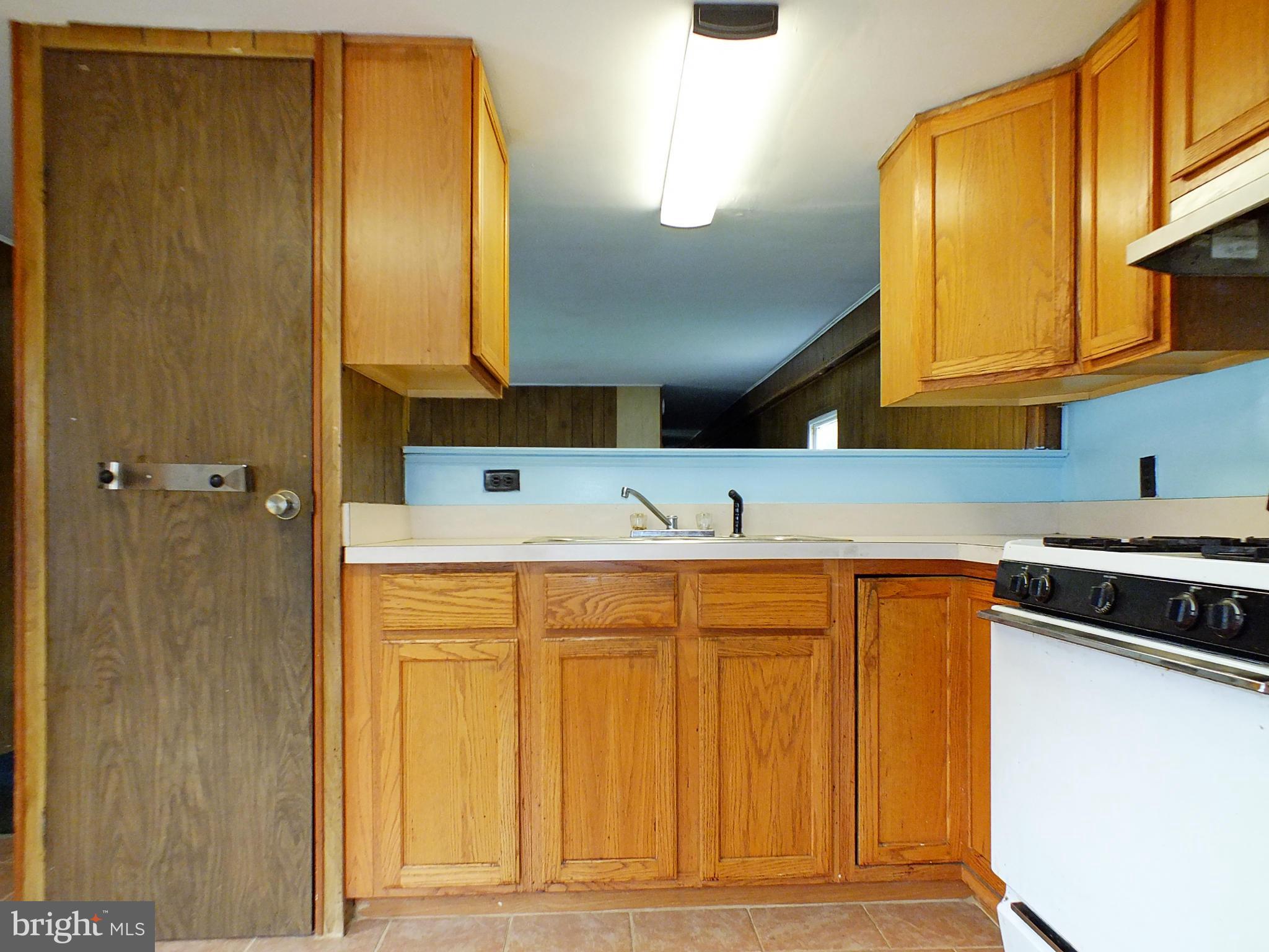 2439 Fairmount Road, Unit 16 Hampstead, MD 21074 - Photo 9 of 17 a kitchen with a sink and a refrigerator