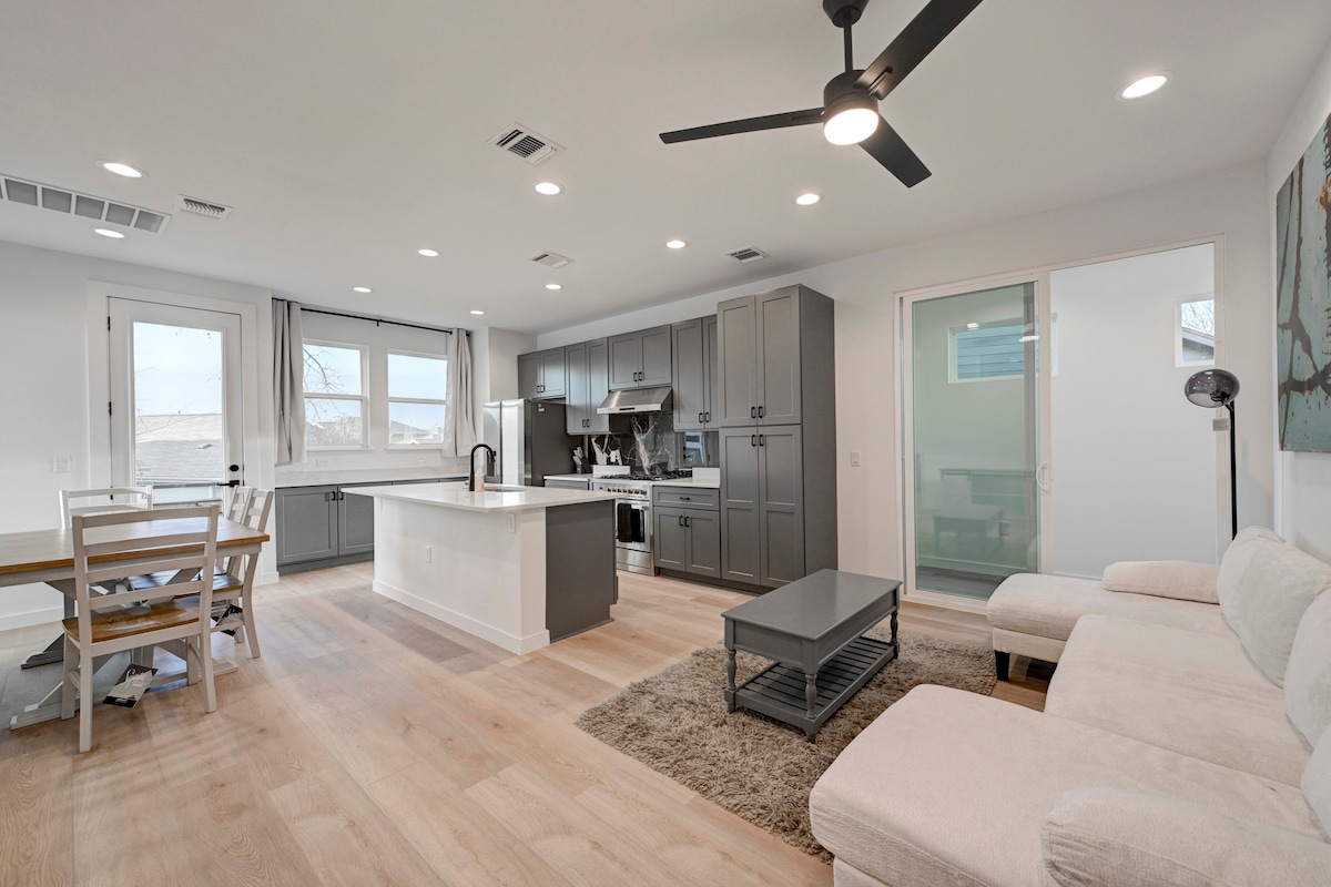2220 Yellow Jacket Lane, Unit 1 Austin, TX 78741 - Photo 1 of 35 An open-concept living space with a contemporary kitchen and light wood flooring.
