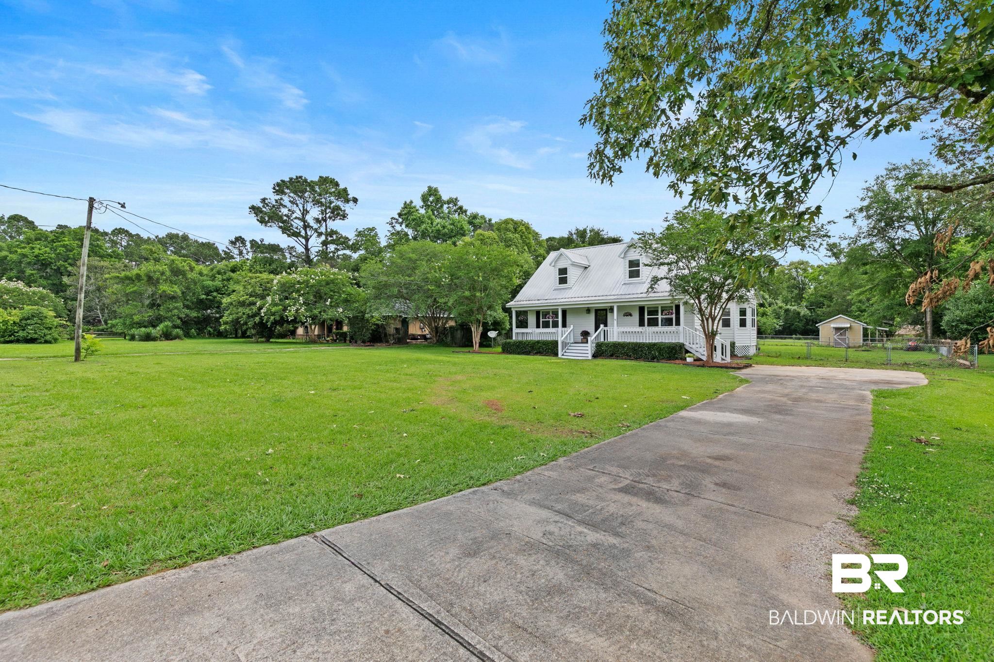 22810 High Ridge Road Fairhope, AL 36532 - Photo 11 of 78 White two-story home with a metal roof and dormer windows