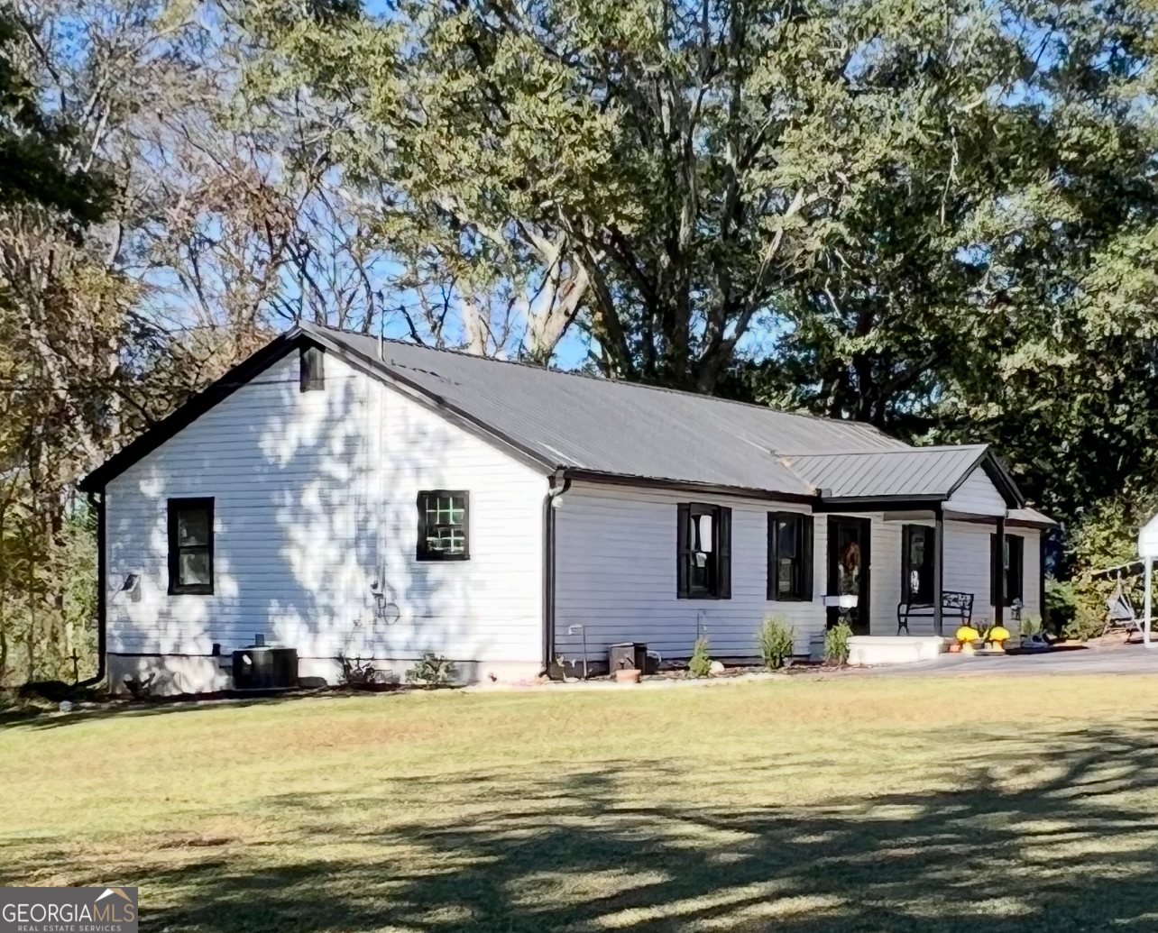 a front view of house with yard and swimming pool