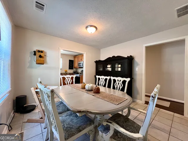 a dining room with furniture and window