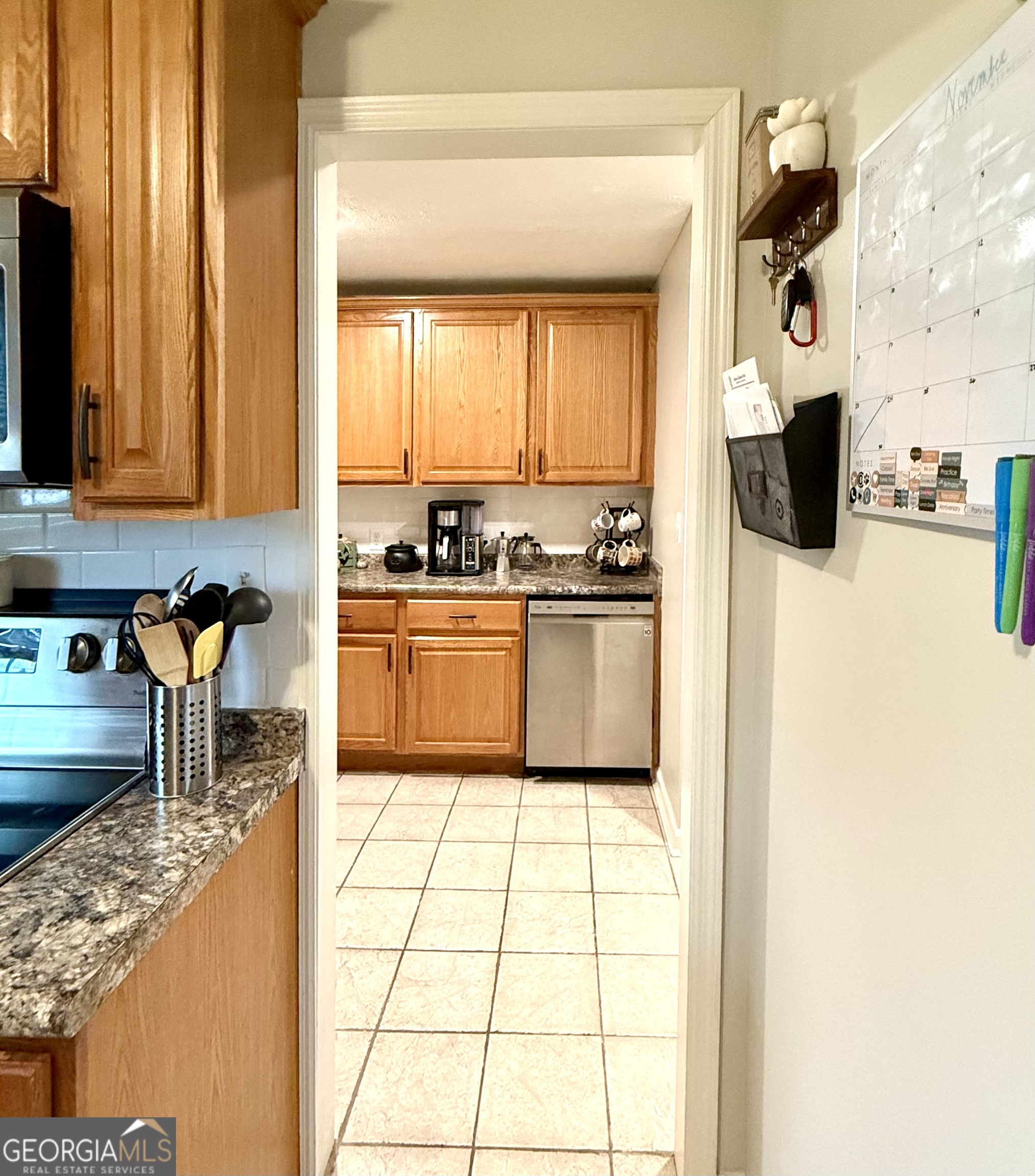 554 Spring Street Commerce, GA 30529 - Photo 17 of 58 a kitchen with stainless steel appliances granite countertop a stove a sink and a microwave