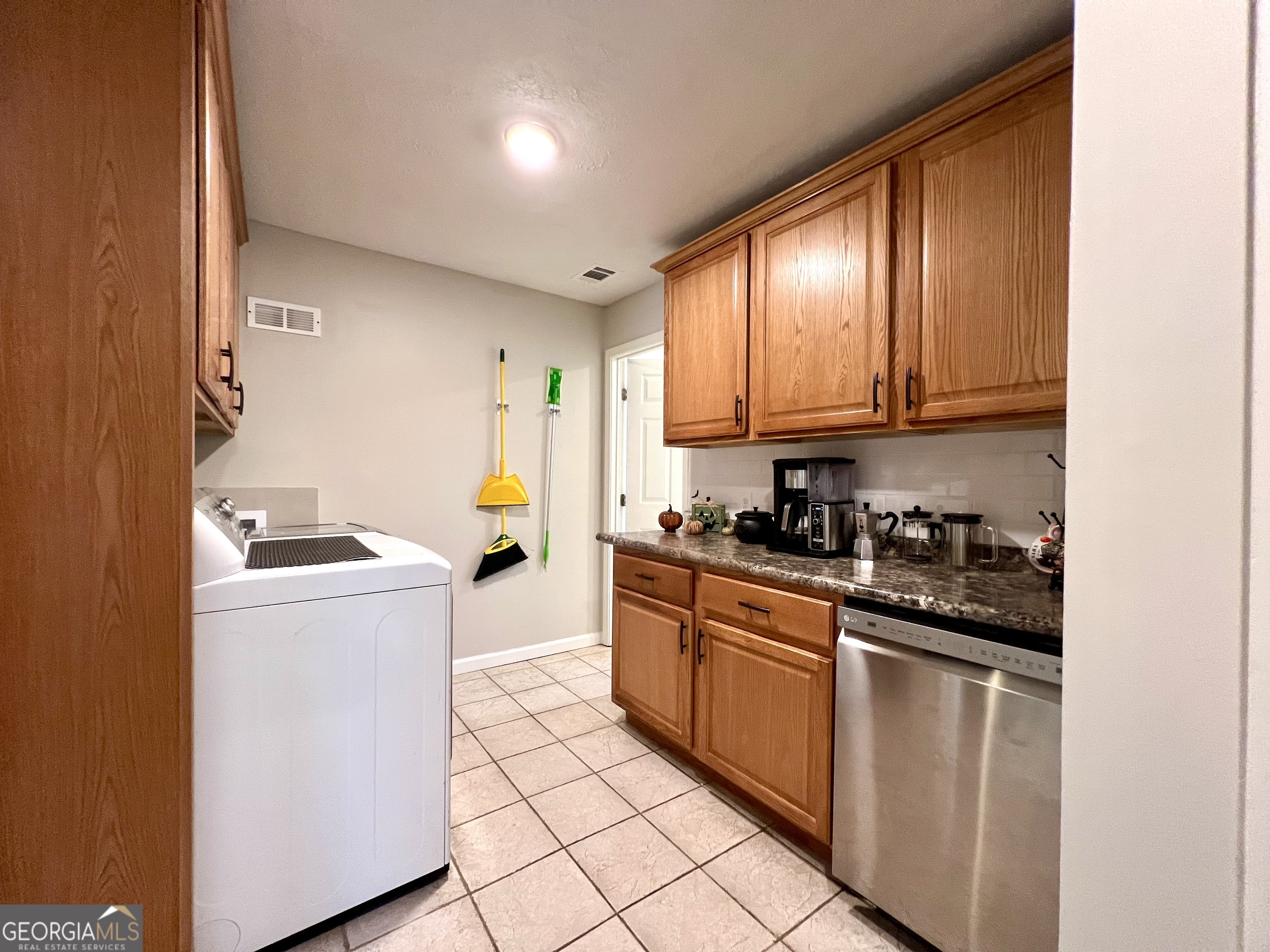554 Spring Street Commerce, GA 30529 - Photo 19 of 58 a kitchen with a sink a stove top oven and white stainless steel appliances