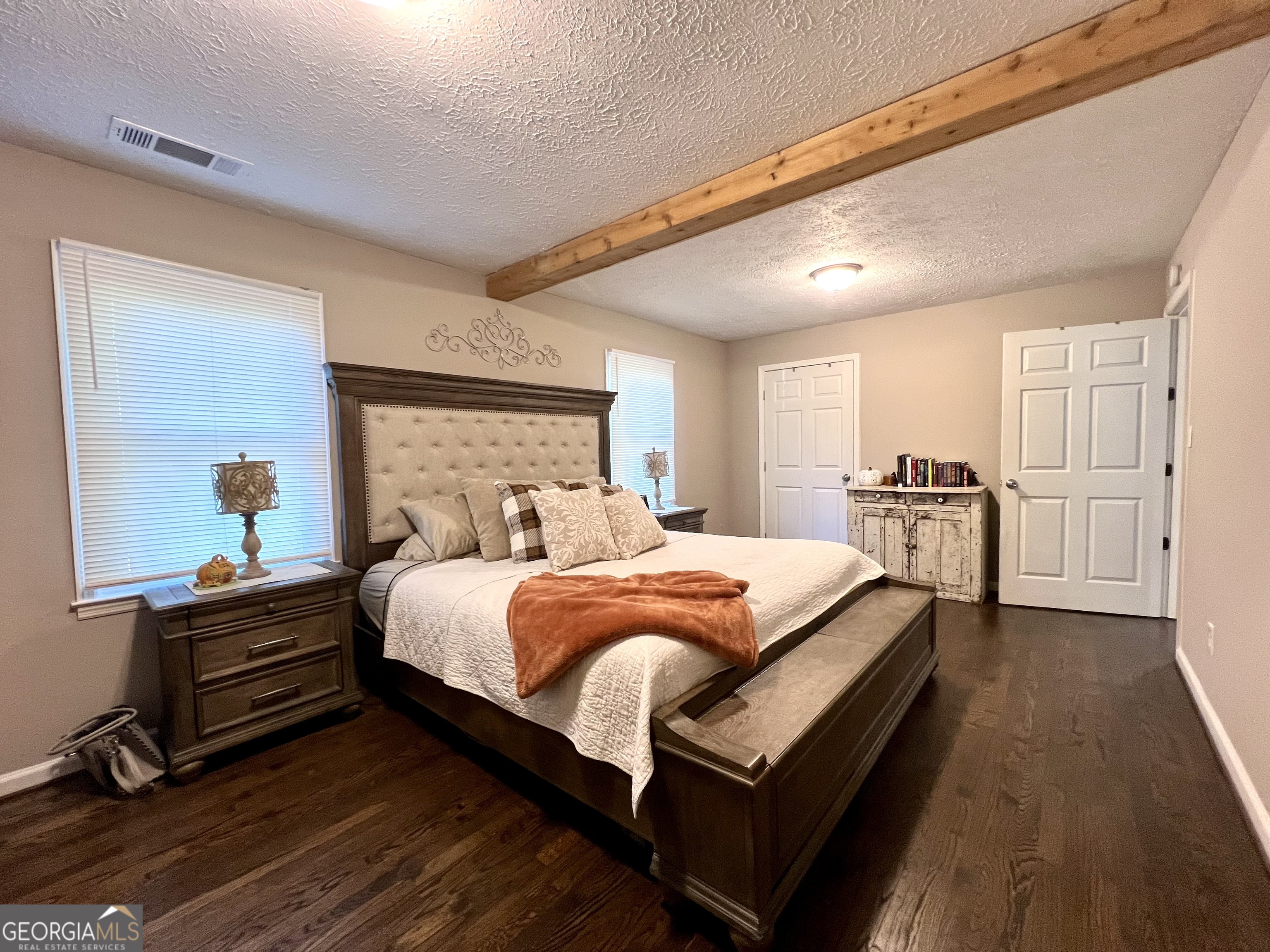 554 Spring Street Commerce, GA 30529 - Photo 21 of 58 a bedroom with bed and wooden floor