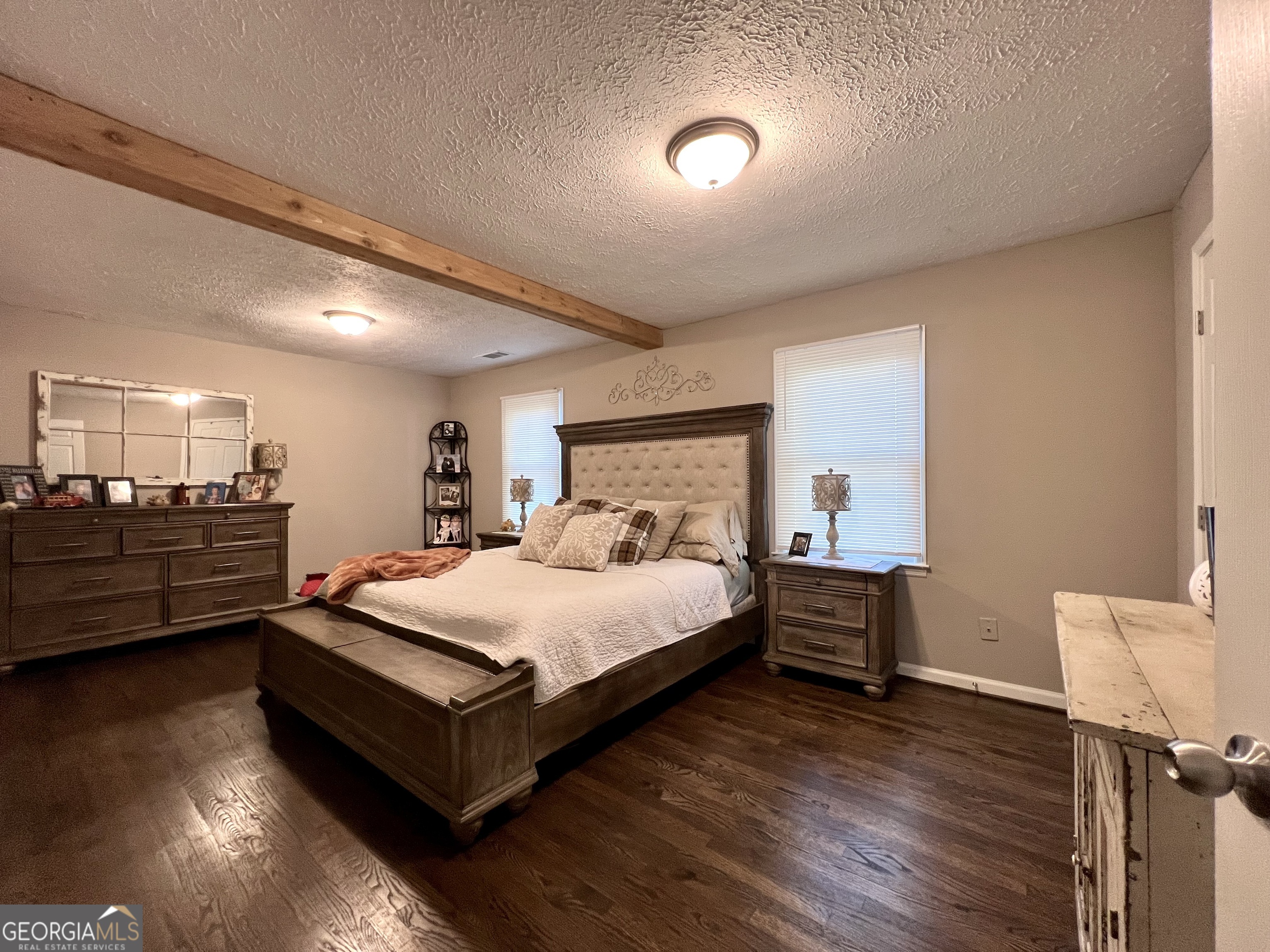 554 Spring Street Commerce, GA 30529 - Photo 22 of 58 a bed room with a bed and a chair