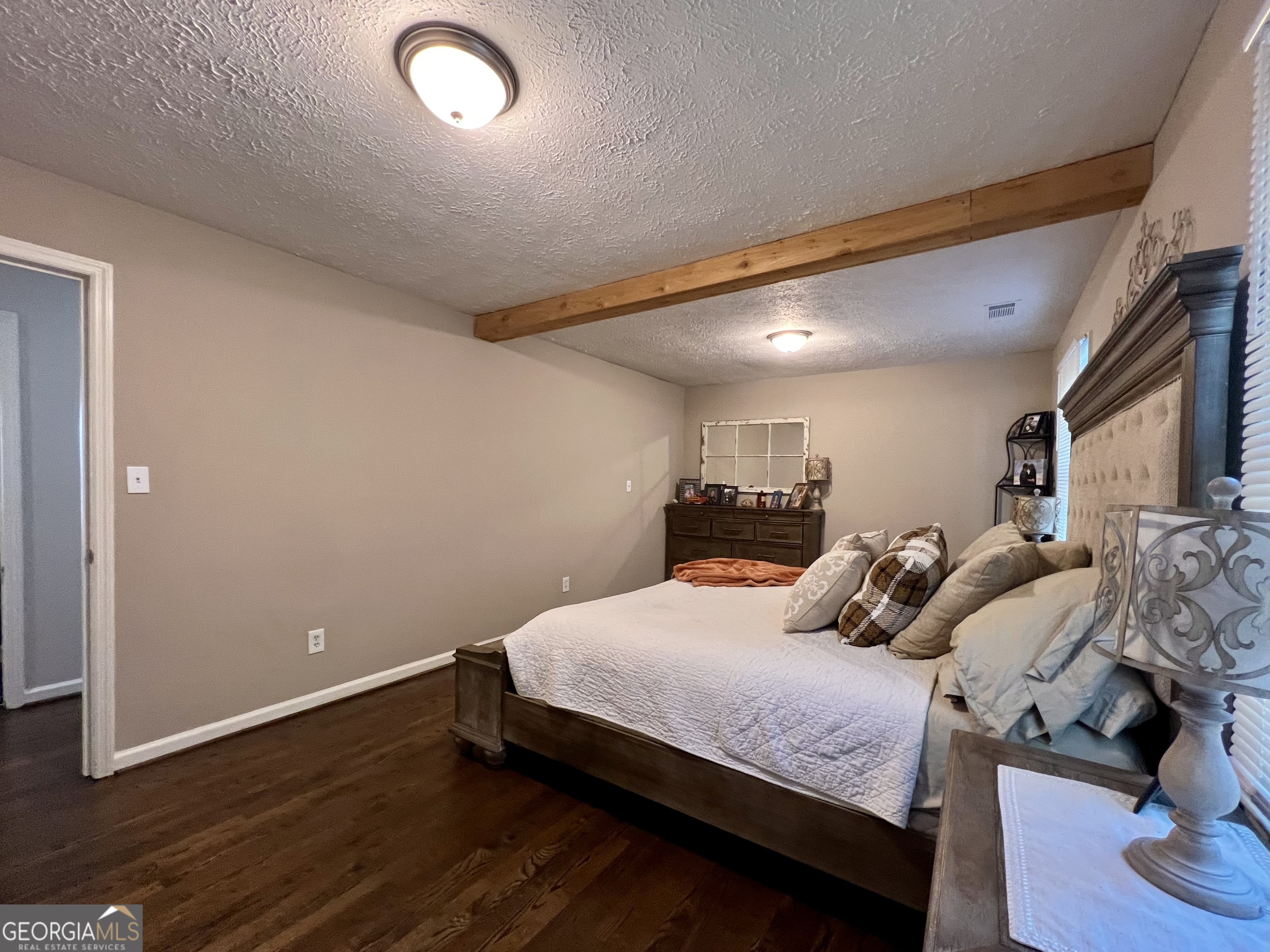 554 Spring Street Commerce, GA 30529 - Photo 24 of 58 a bedroom with a bed and a night stand