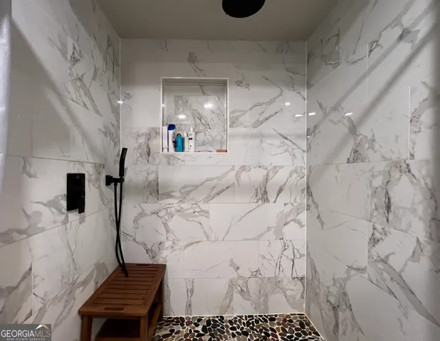 a bathroom with a bathtub and a shower