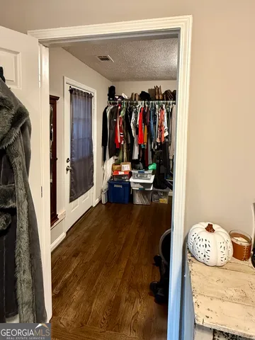 a view of a room with furniture and wooden floor