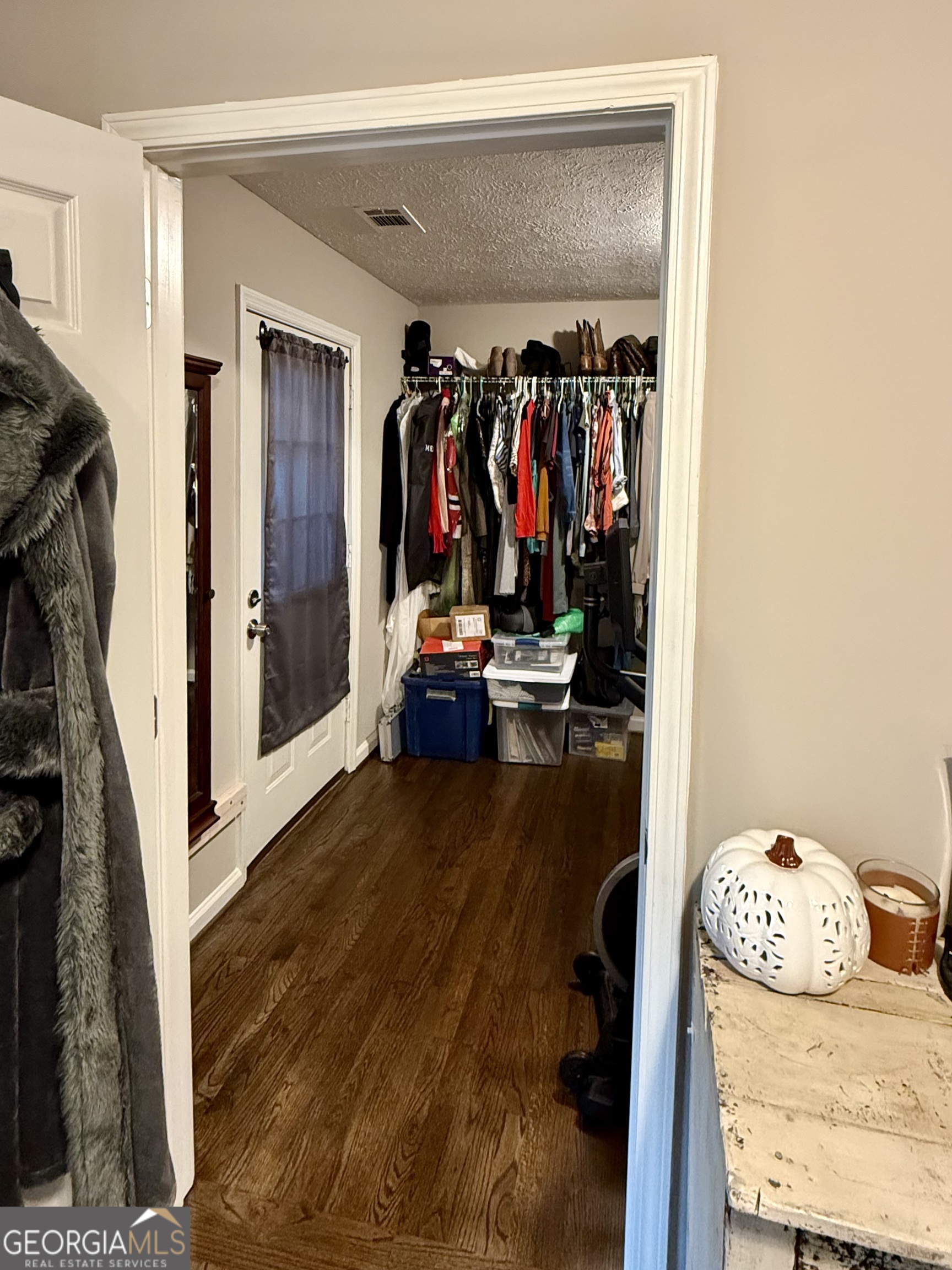 554 Spring Street Commerce, GA 30529 - Photo 30 of 58 a view of walk in closet with clothes and shoes
