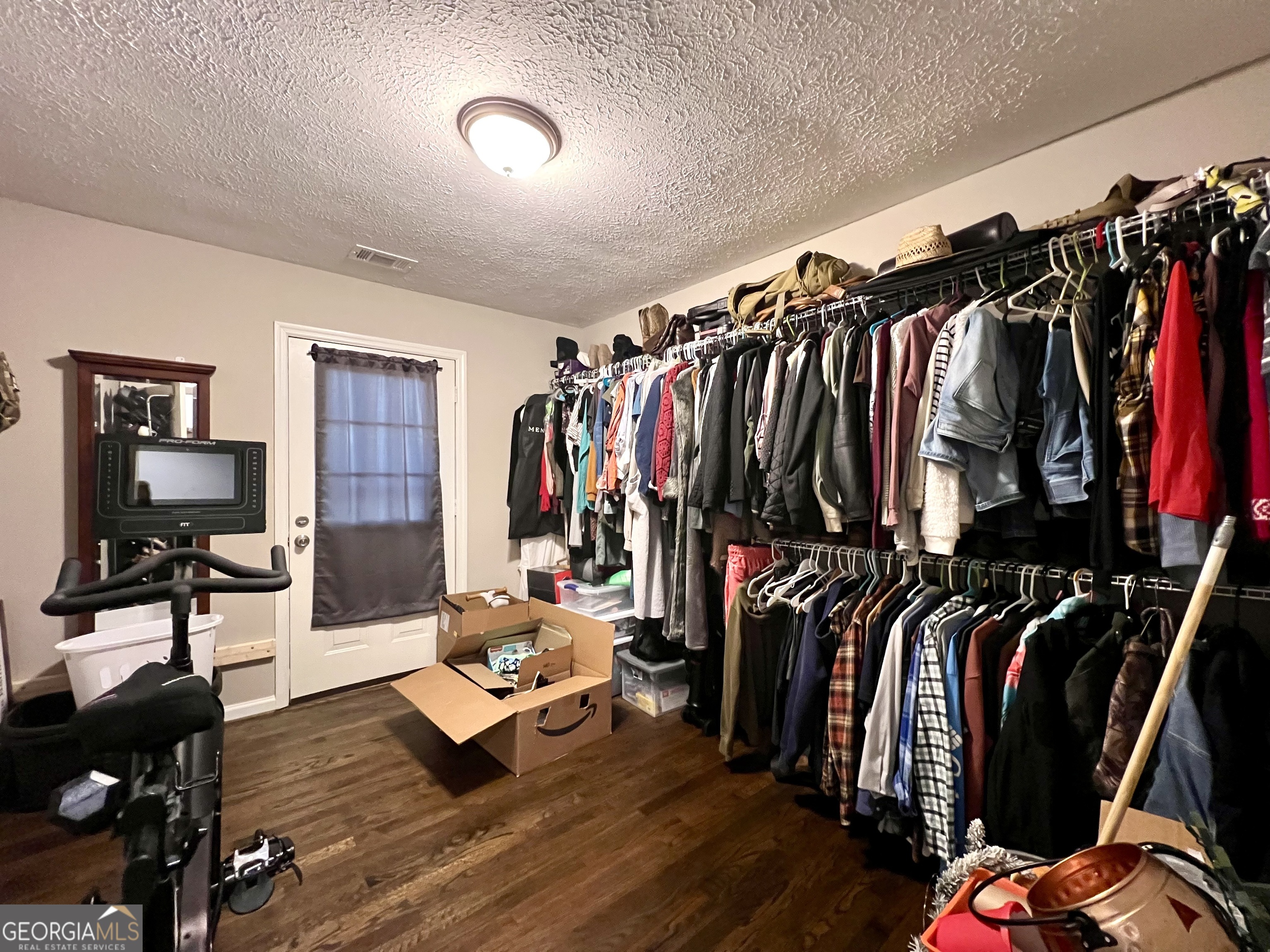 554 Spring Street Commerce, GA 30529 - Photo 31 of 58 a view of walk in closet with clothes and shoes