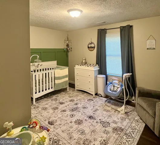 a bathroom with a toilet and a shower curtain