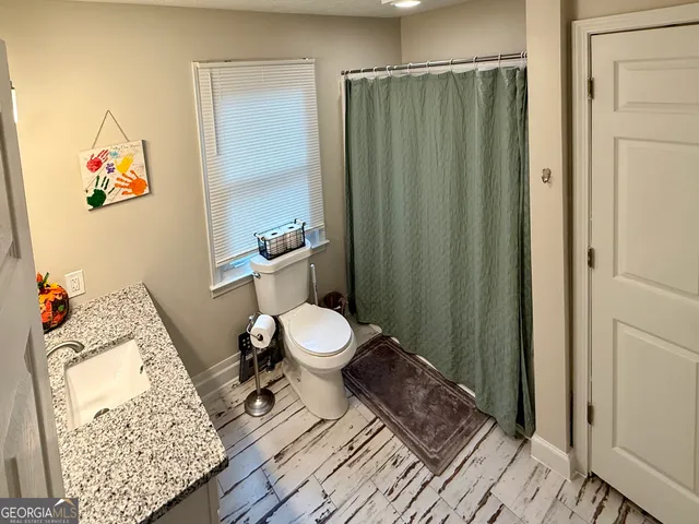 a bedroom with double bed and a window