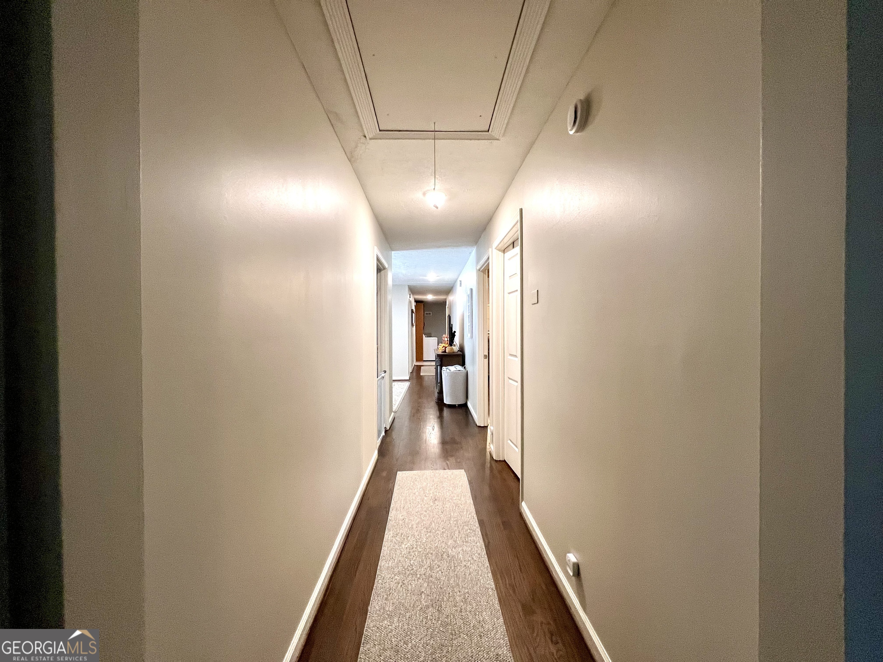 554 Spring Street Commerce, GA 30529 - Photo 44 of 58 a view of a hallway with wooden floor and staircase
