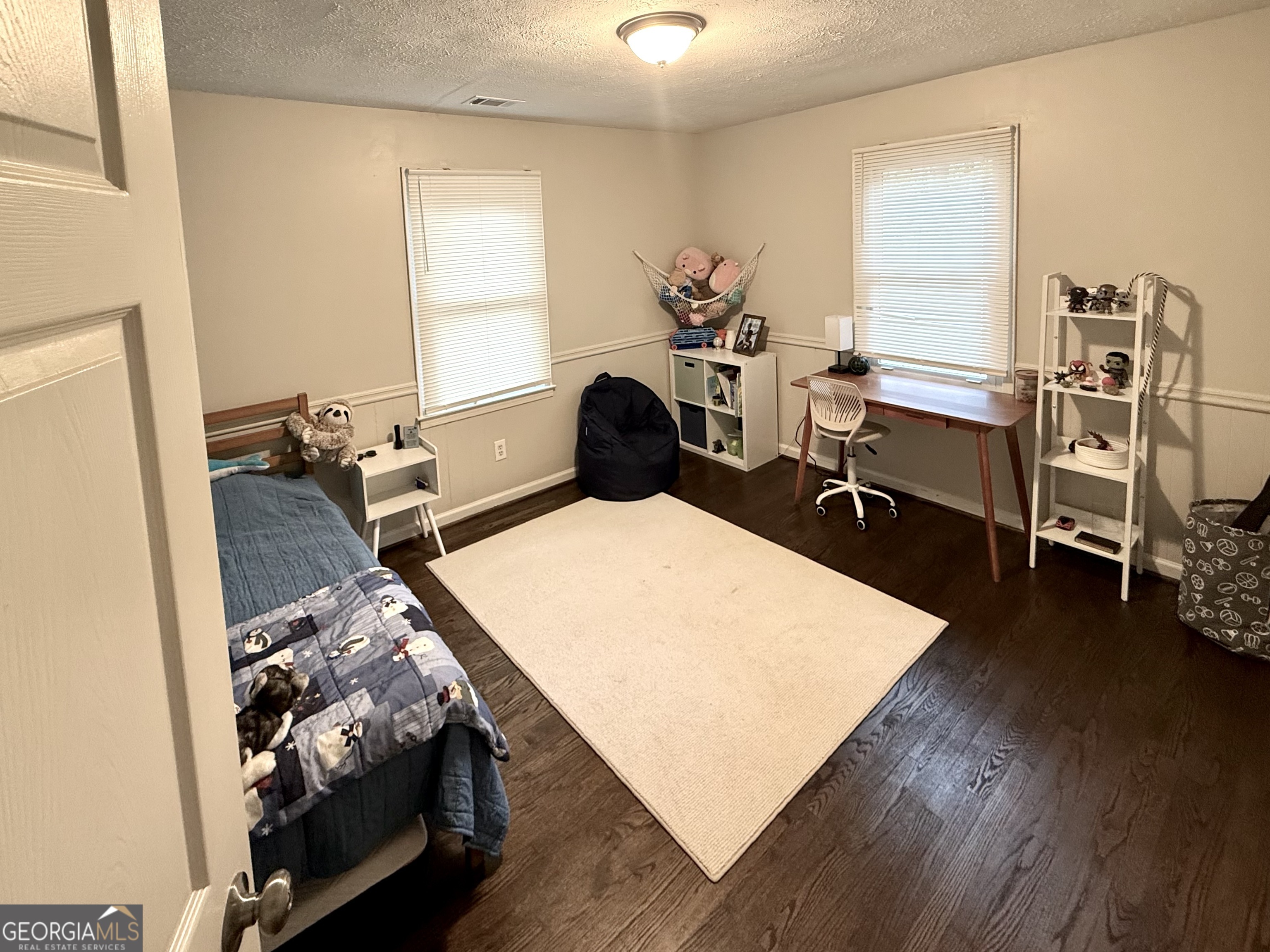 554 Spring Street Commerce, GA 30529 - Photo 49 of 58 a bedroom with furniture and a wooden floor