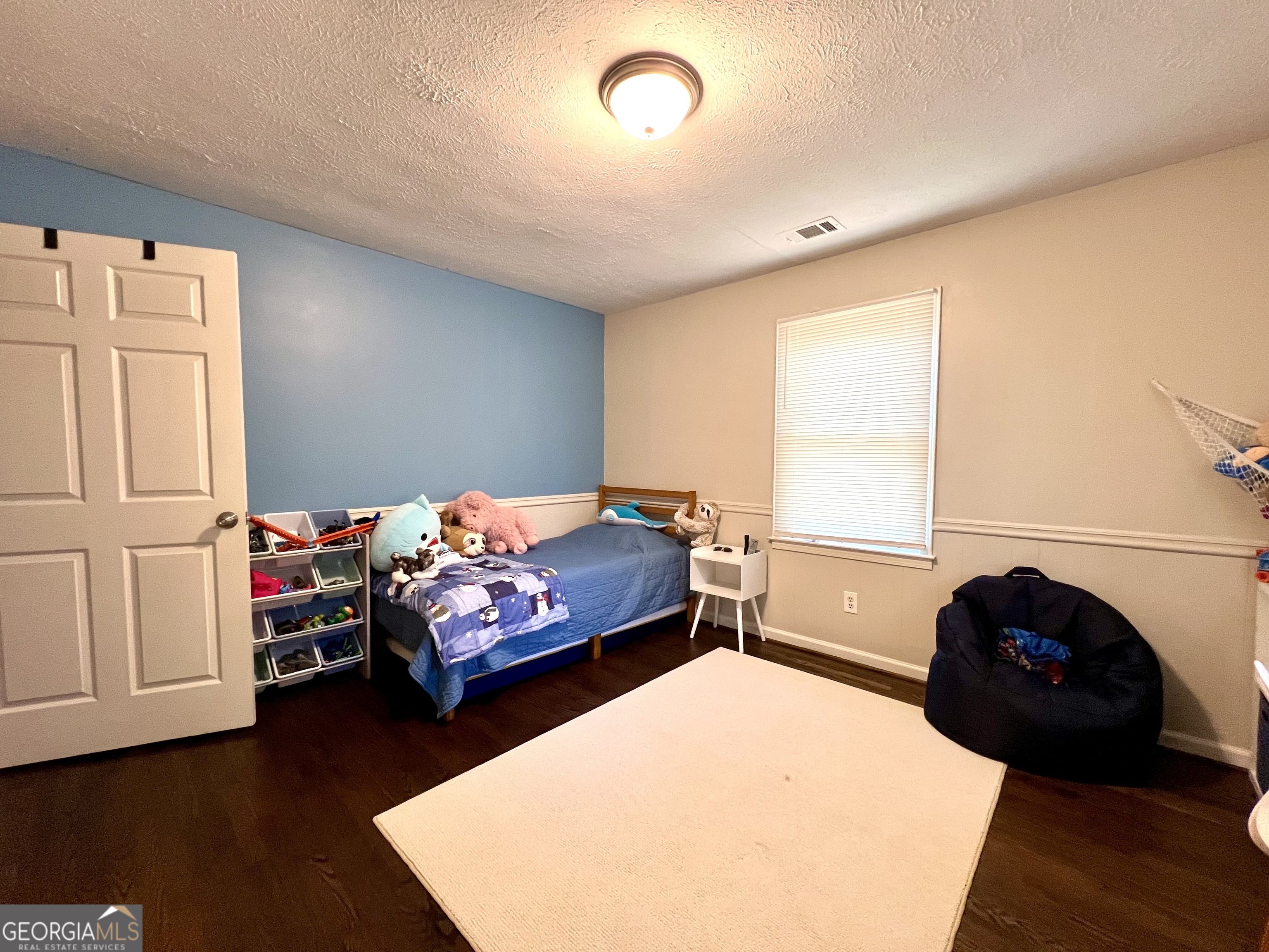 554 Spring Street Commerce, GA 30529 - Photo 51 of 58 a bedroom with a bed and a couch