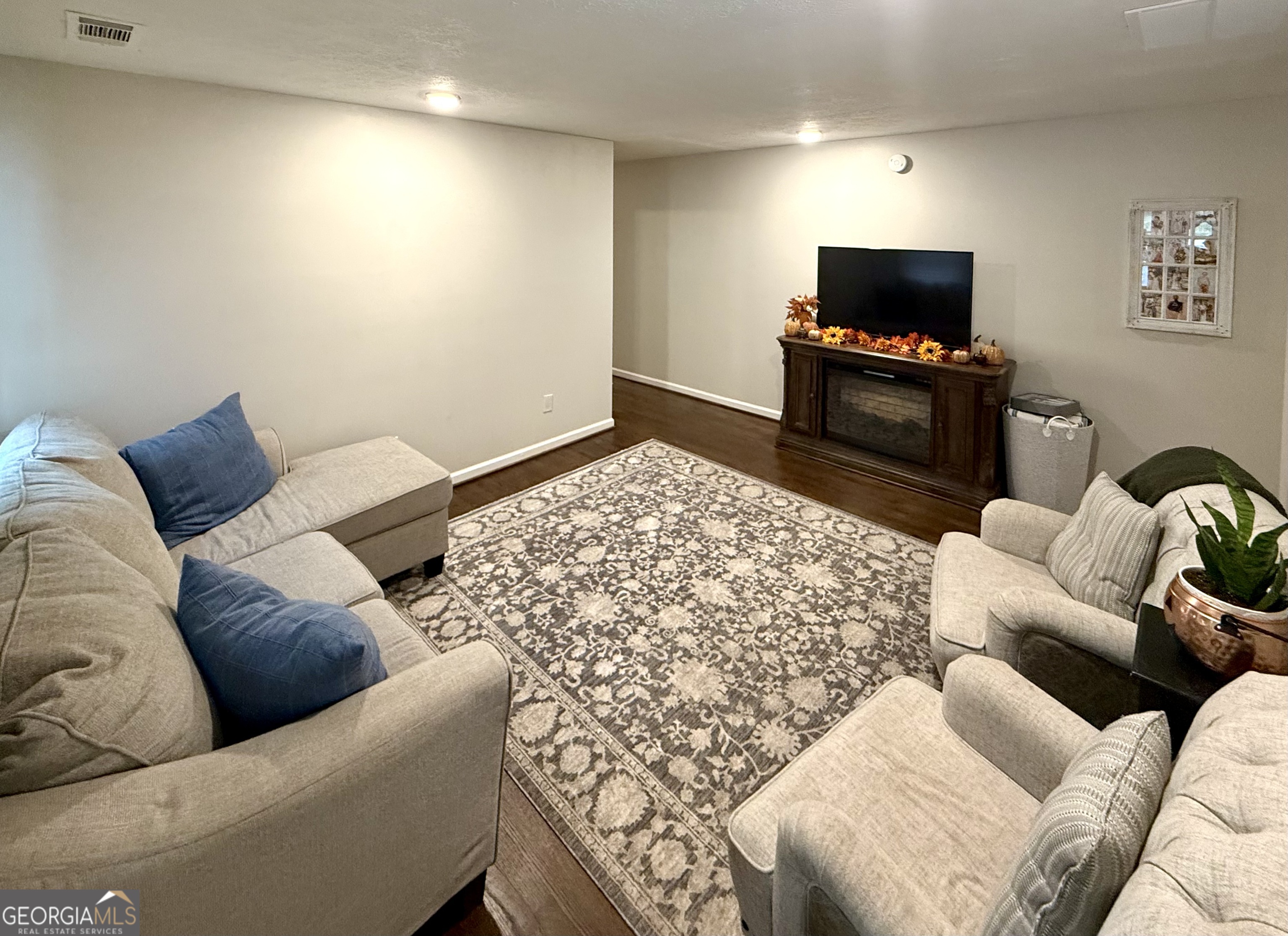 554 Spring Street Commerce, GA 30529 - Photo 9 of 58 a living room with furniture and a flat screen tv
