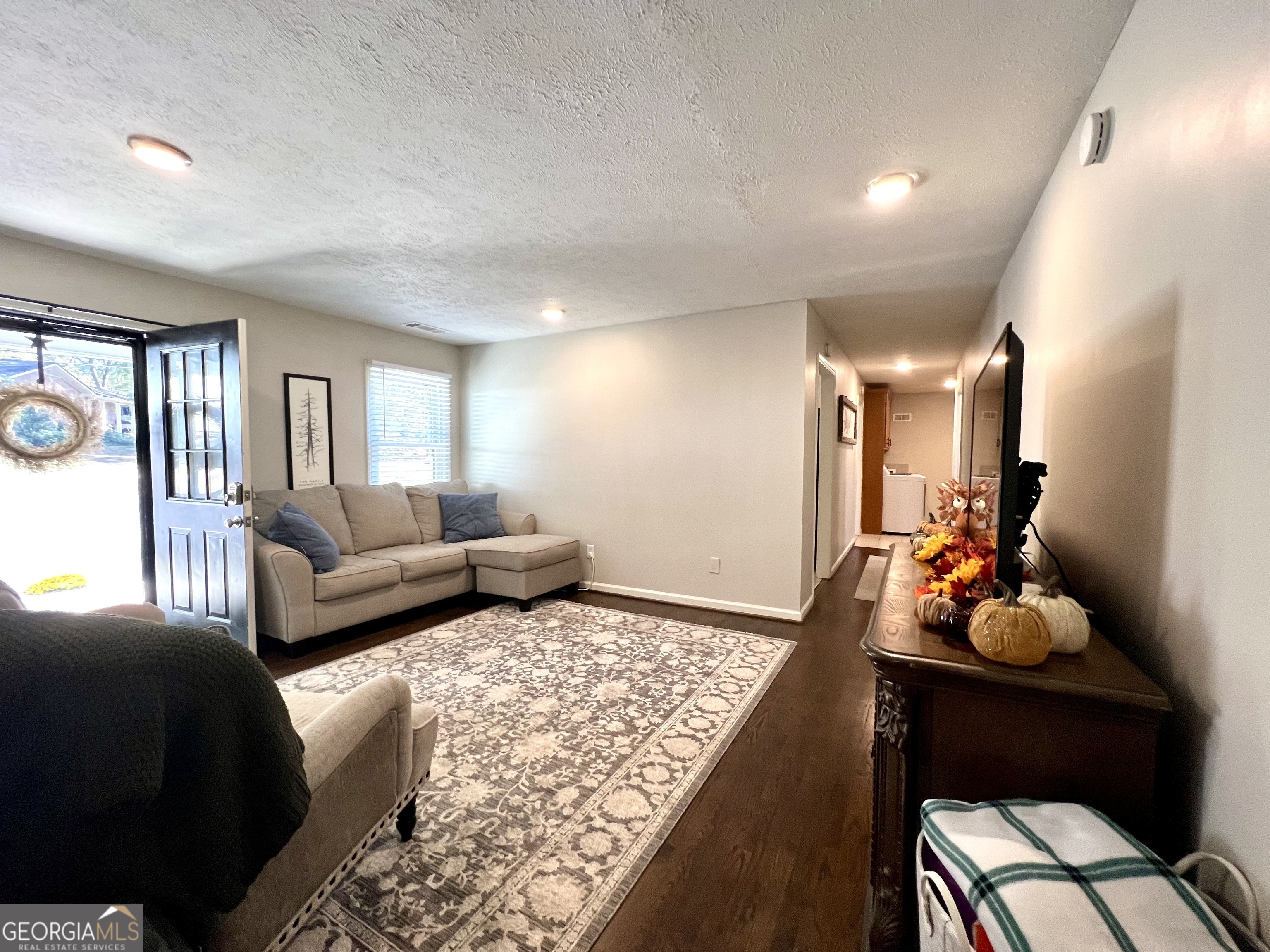 554 Spring Street Commerce, GA 30529 - Photo 10 of 58 a living room with furniture and dresser with wooden floor