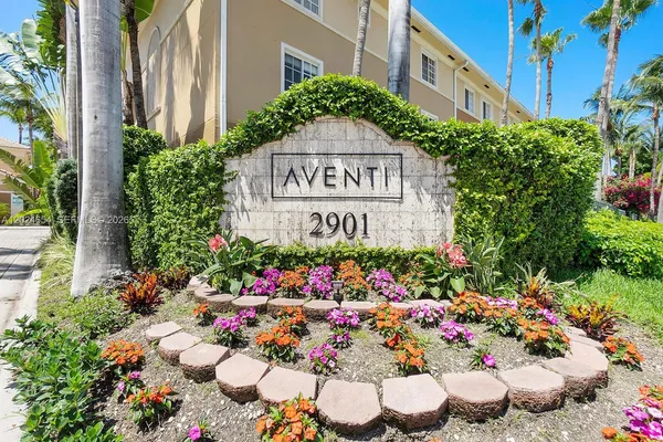 a sign that is in front of flowers