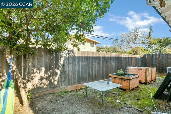 a backyard of a house with table and chairs