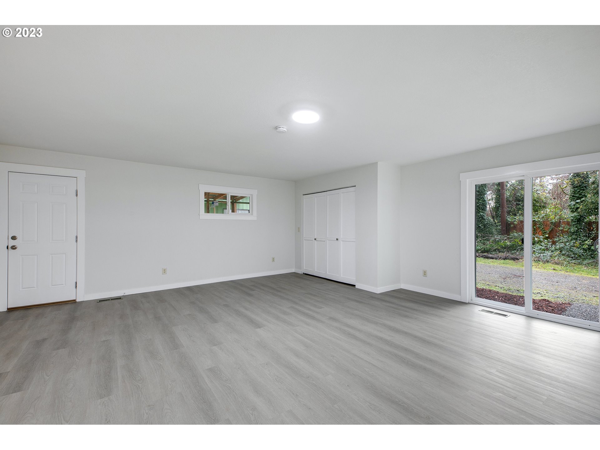 25331 South Larkin Road Beavercreek, OR 97004 - Photo 14 of 44 an empty room with wooden floor and windows