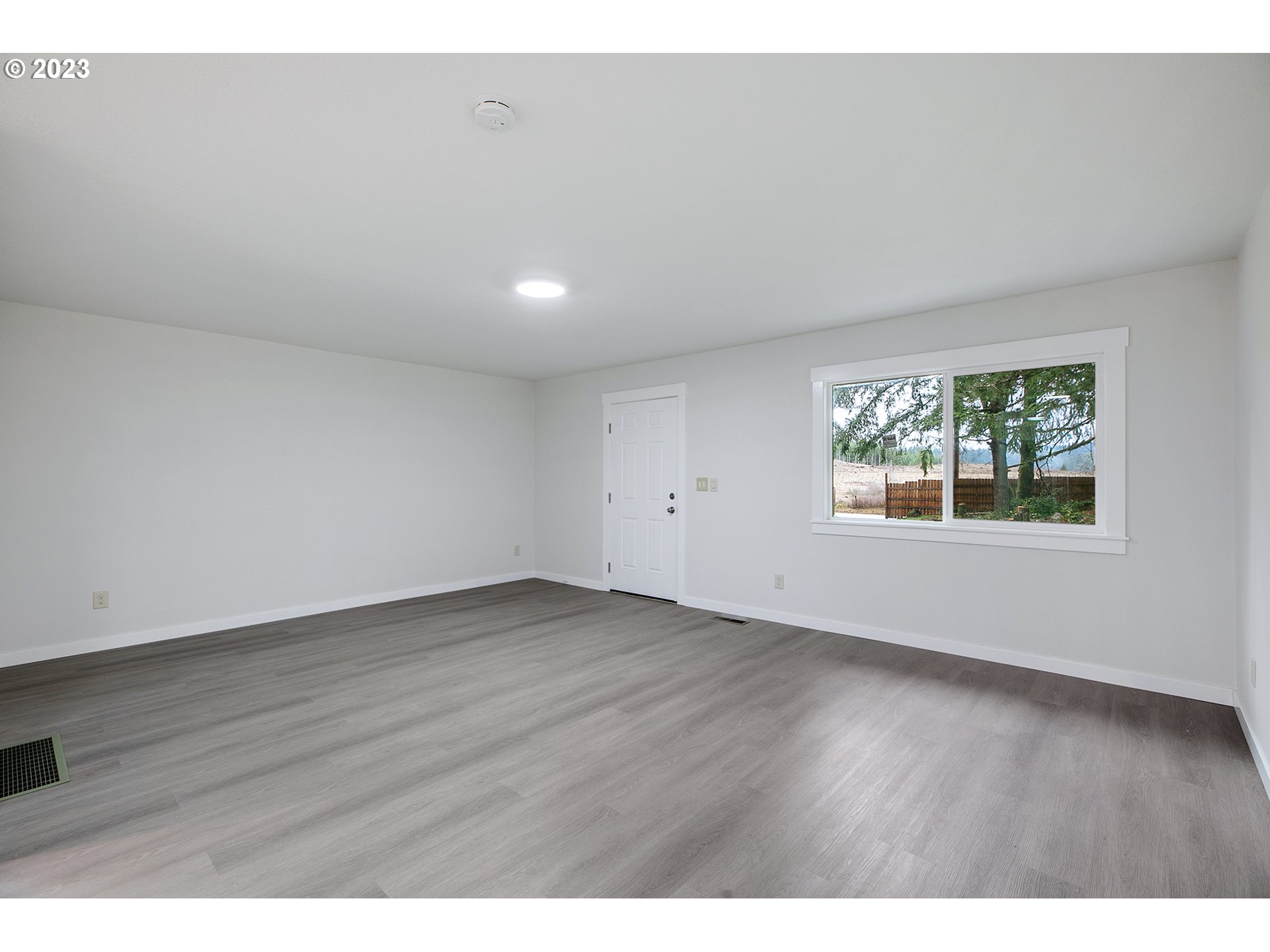 25331 South Larkin Road Beavercreek, OR 97004 - Photo 20 of 44 a view of an empty room with wooden floor and a window